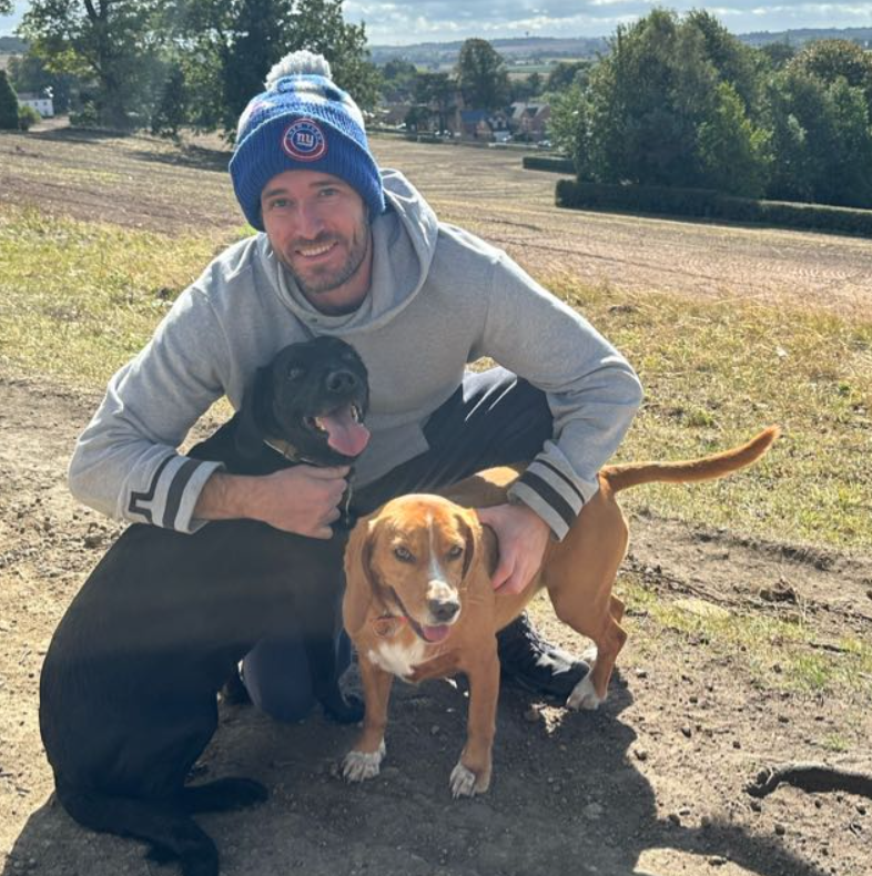 Fraser, founder of The Zoomies Crew, with a dog